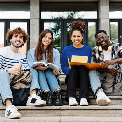 Four students gathered together with open books