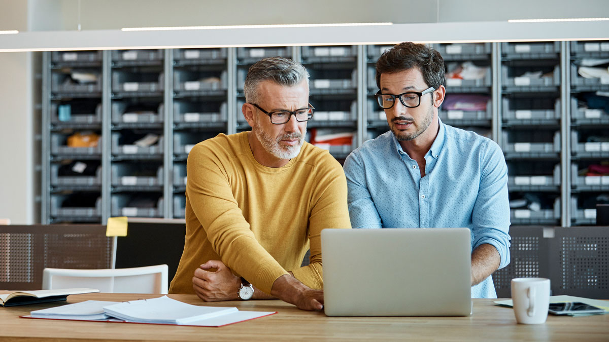 Men working on computer